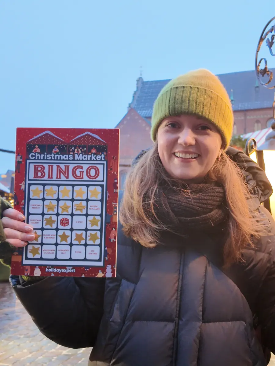 Chelsea with bingo card at Riga Christmas Market
