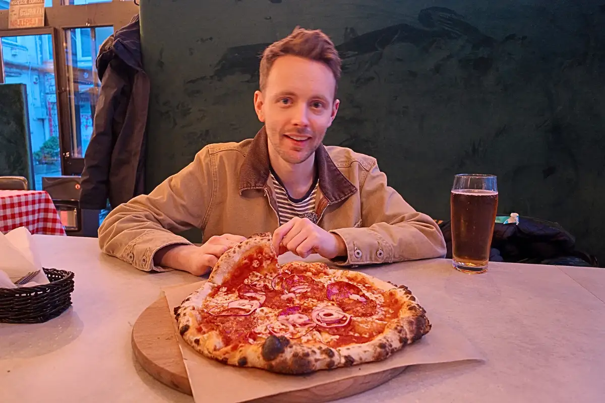 James with a pizza in Lodz, Poland