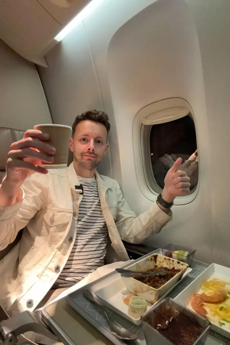 James with a drink in eva Premium Economy
